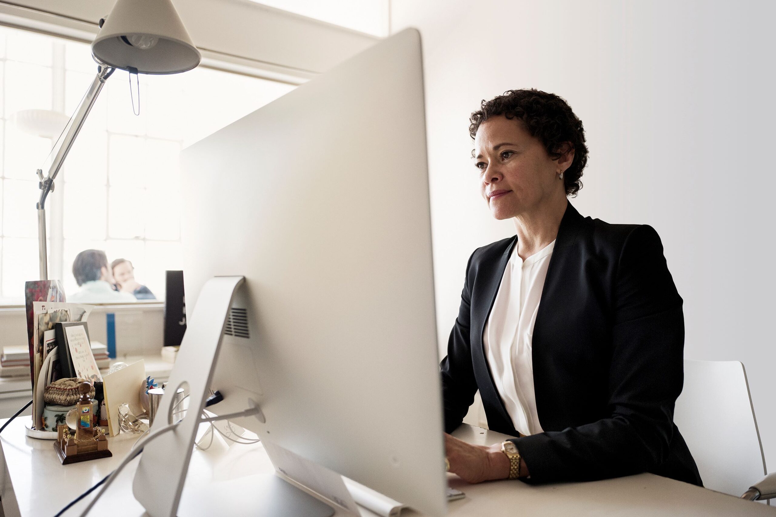 a person sitting at a desk in front of a computer