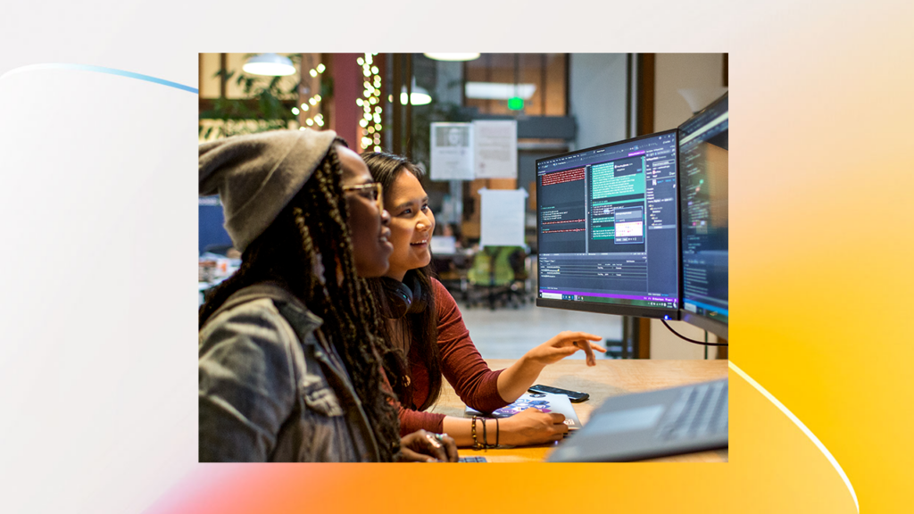 two women in front of a computer