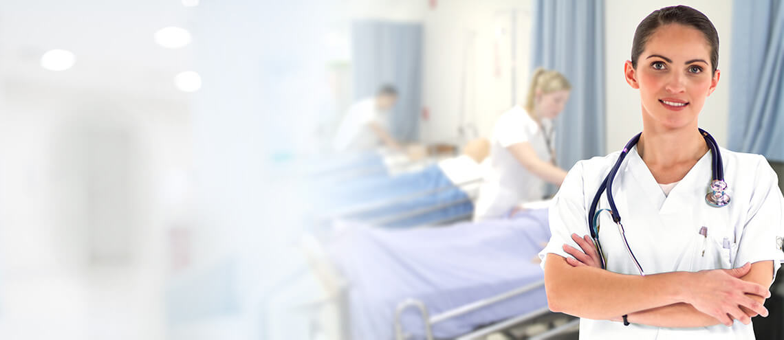 Woman in hospital gown next to hospital bed