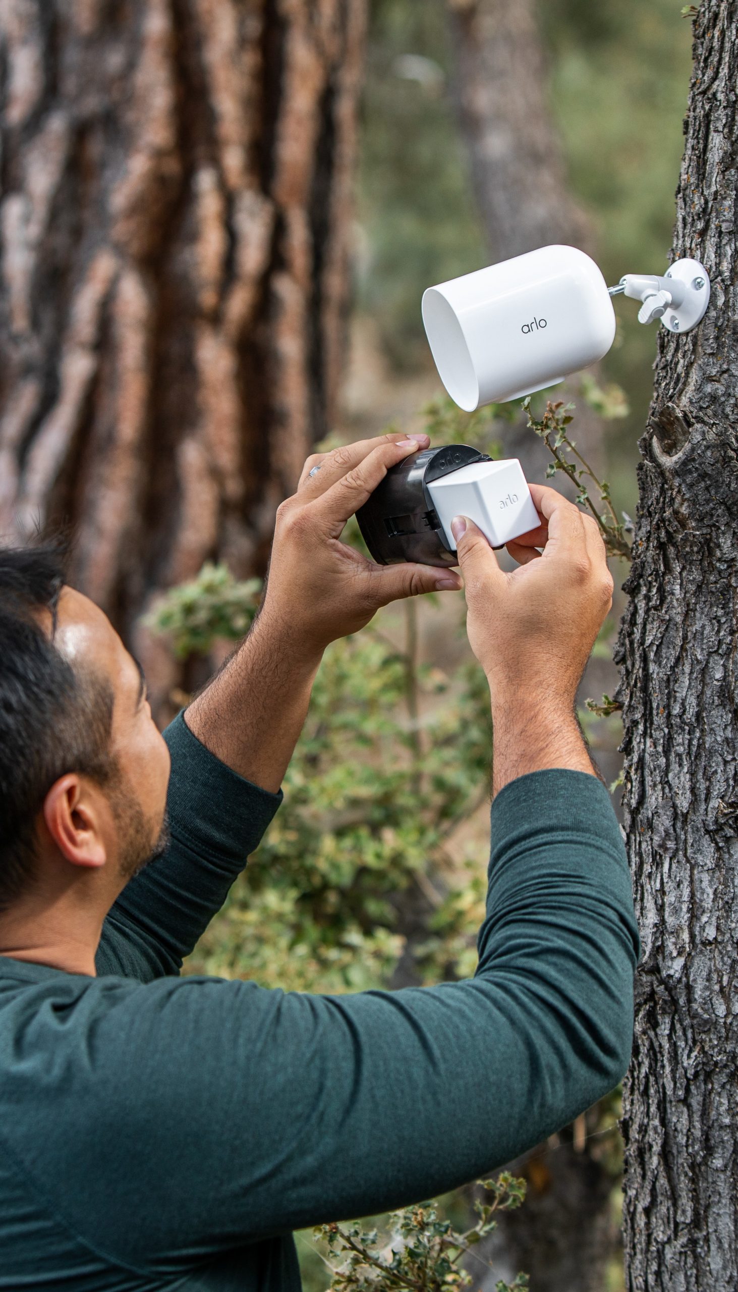 man hiding Arlo outdoor camera