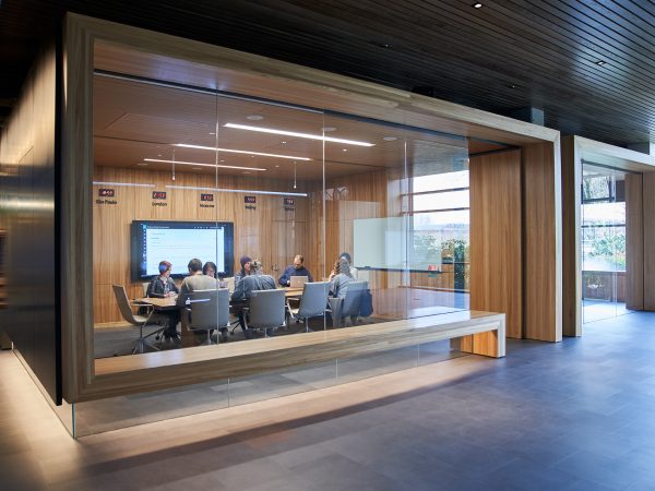 Eight people seated around a conference room in an office building