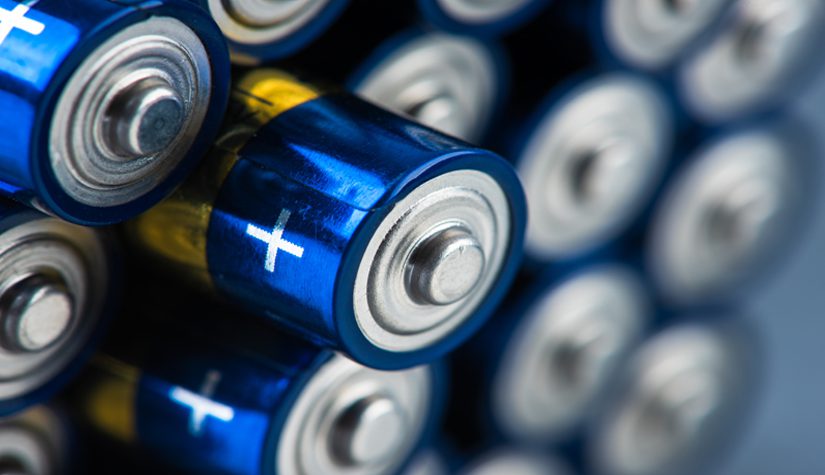 Stack of alkaline batteries size AAA with selective focus.