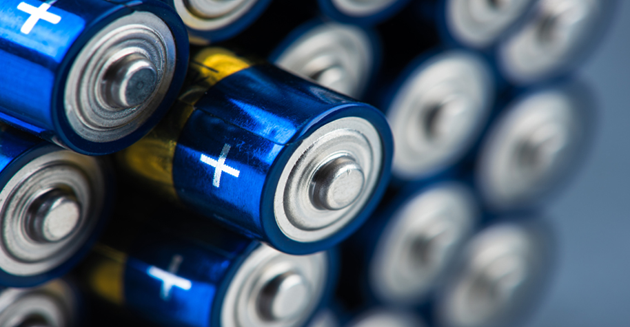 Stack of alkaline batteries size AAA with selective focus.