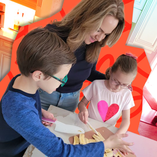 Mom with children cooking in the kitchen on Valentine's Day