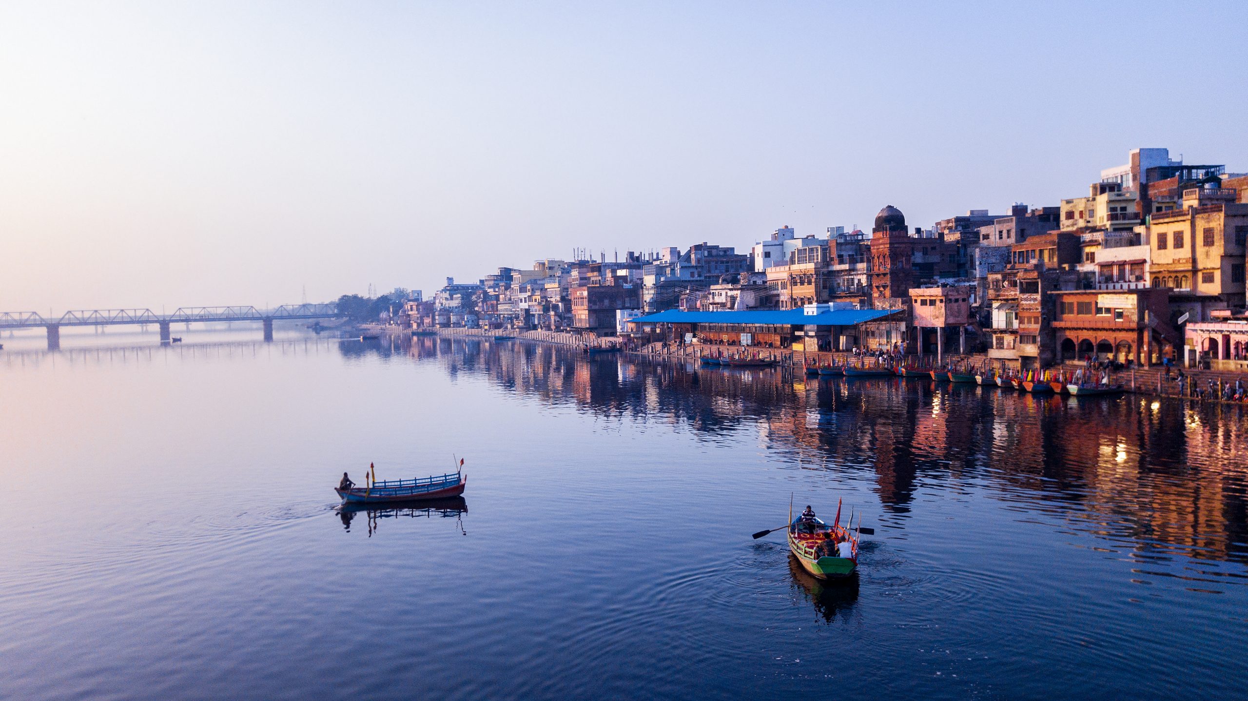 some boats on the water by an Indian coastal town