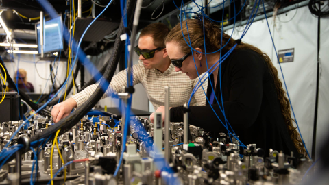 Two Quantinuum scientists working in a lab