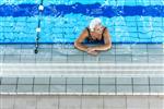 Senior Citizen Woman Standing In The Indoor Pool