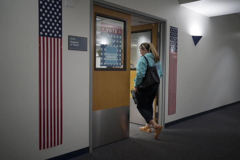 Cari-Ann Burgess, interim Registrar of Voters for Washoe County, Nev., arrives at the office Saturday, Sept. 21, 2024, in Reno, Nev. (AP Photo/John Locher)