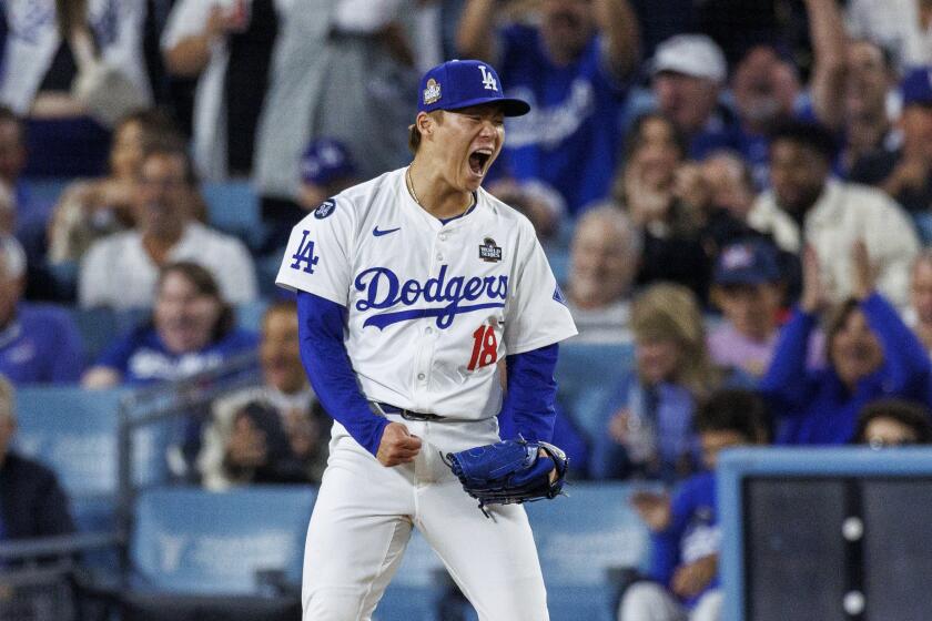 Dodgers pitcher Yoshinobu Yamamoto celebrates after striking out Aaron Judge in the World Series at Dodger Stadium.