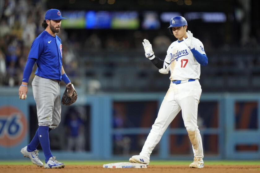 Los Angeles Dodgers' Shohei Ohtani, puts his hands up as Chicago Cubs shortstop.