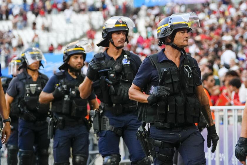 FILE - Police are seen near the pitch during a men's semifinal soccer match between Morocco and Spain at the 2024 Summer Olympics, Monday, Aug. 5, 2024, at Marseille Stadium in Marseille, France. Spain won 2-1. (AP Photo/Julio Cortez, File)