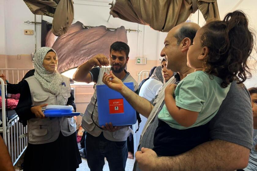 GAZA, ISRAEL-Sept. 9, 2024-A polio vaccine campaign is underway in Gaza. Medical staff and parents at a vaccination site in Khan Younis. (Bilal Shbair / For the Times)