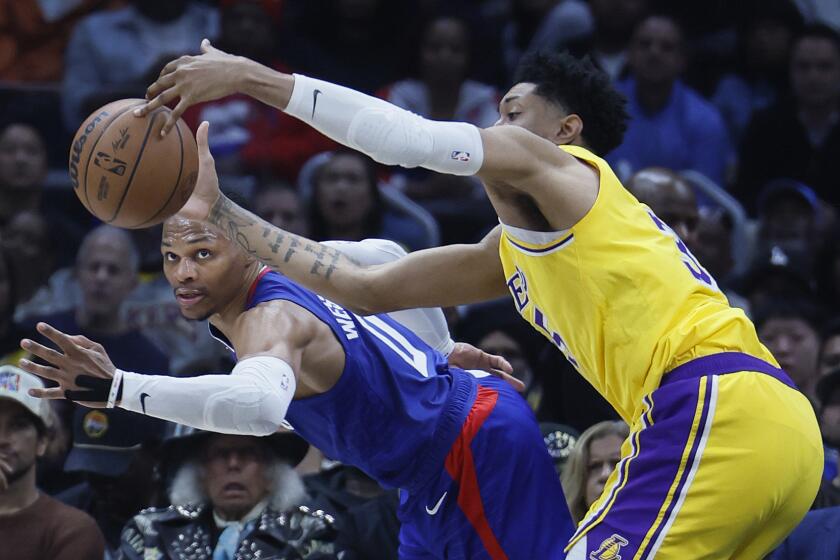 Los Angeles, CA - January 23: Clippers point guard Russell Westbrook, #0, battles Lakers forward Christian Wood, #35 for control of a loose ball in the second half at Crypto.com Arena in Los Angeles Tuesday, Jan. 23, 2024. Clippers beat the Lakers 116-127. (Allen J. Schaben / Los Angeles Times)