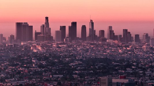 A photo showing the Los Angeles skyline near sunset. The air is hazy.