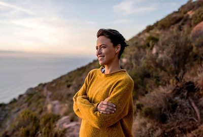 Woman on mountainside looking into the distance