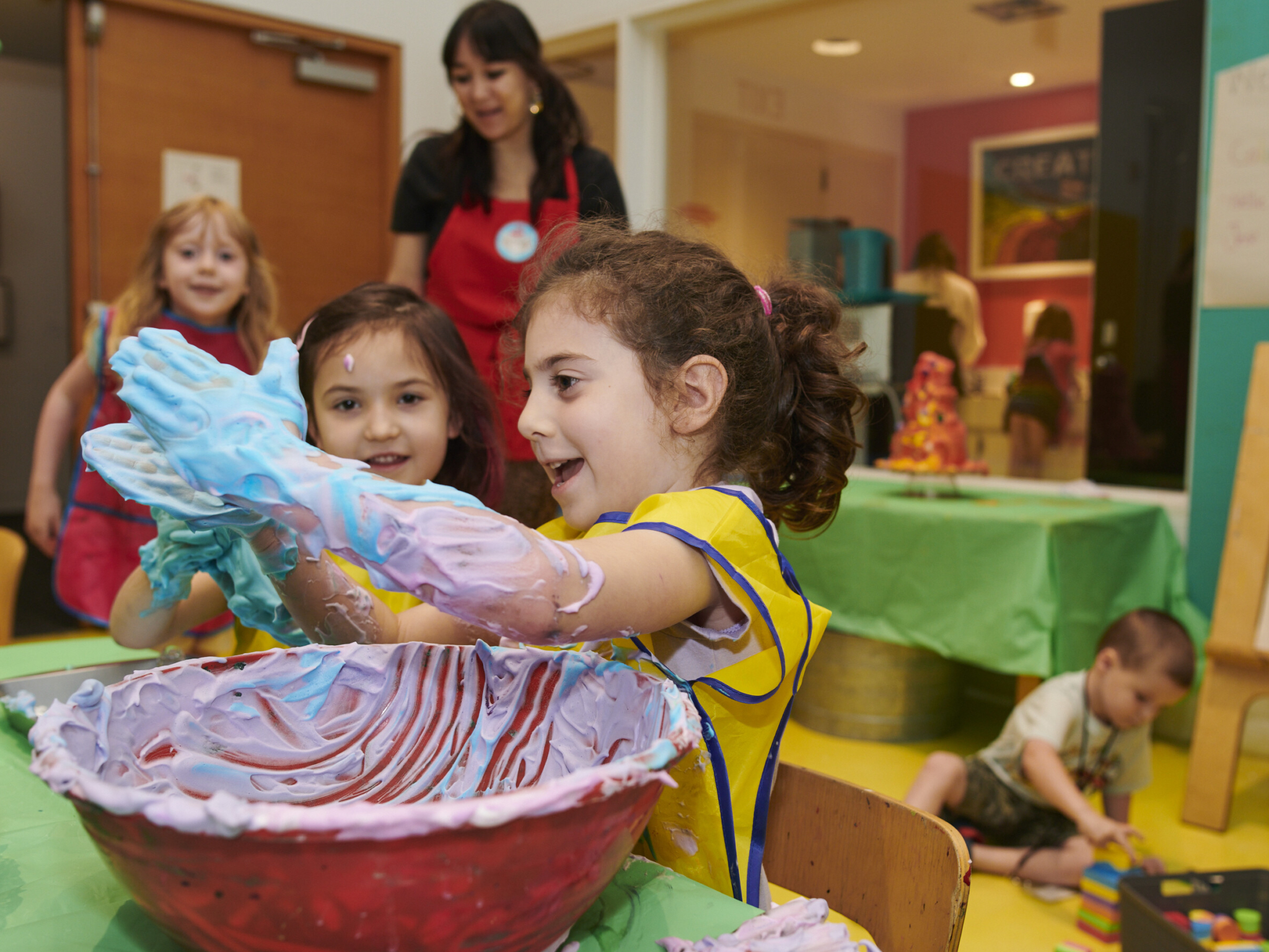 kids playing with foam in a bowl