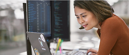 A man and a woman working on a computer