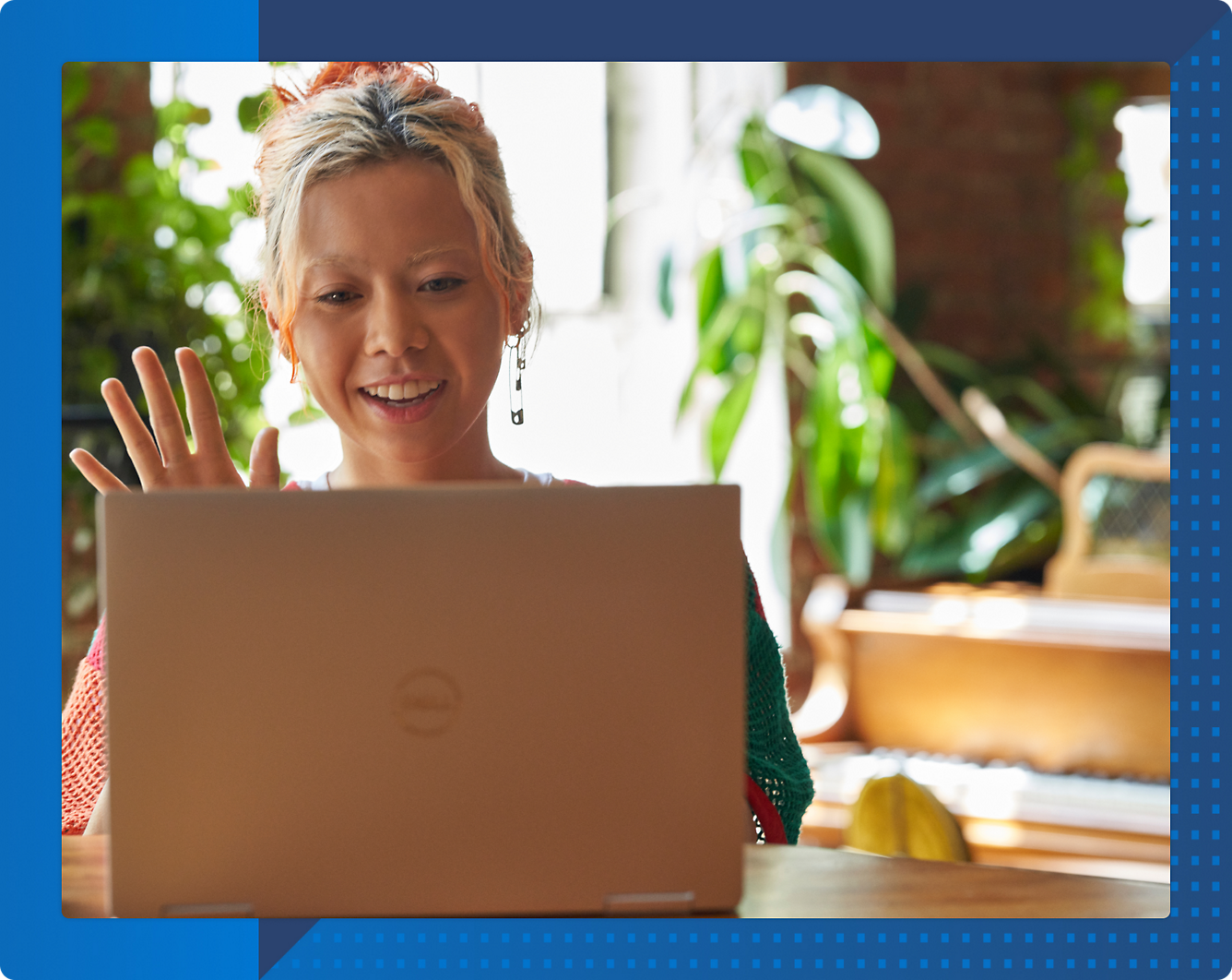 A person waving at a computer