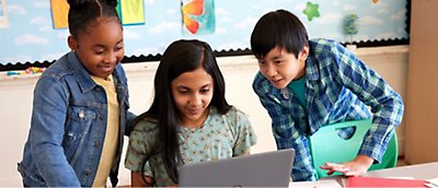 A group of children looking at a computer