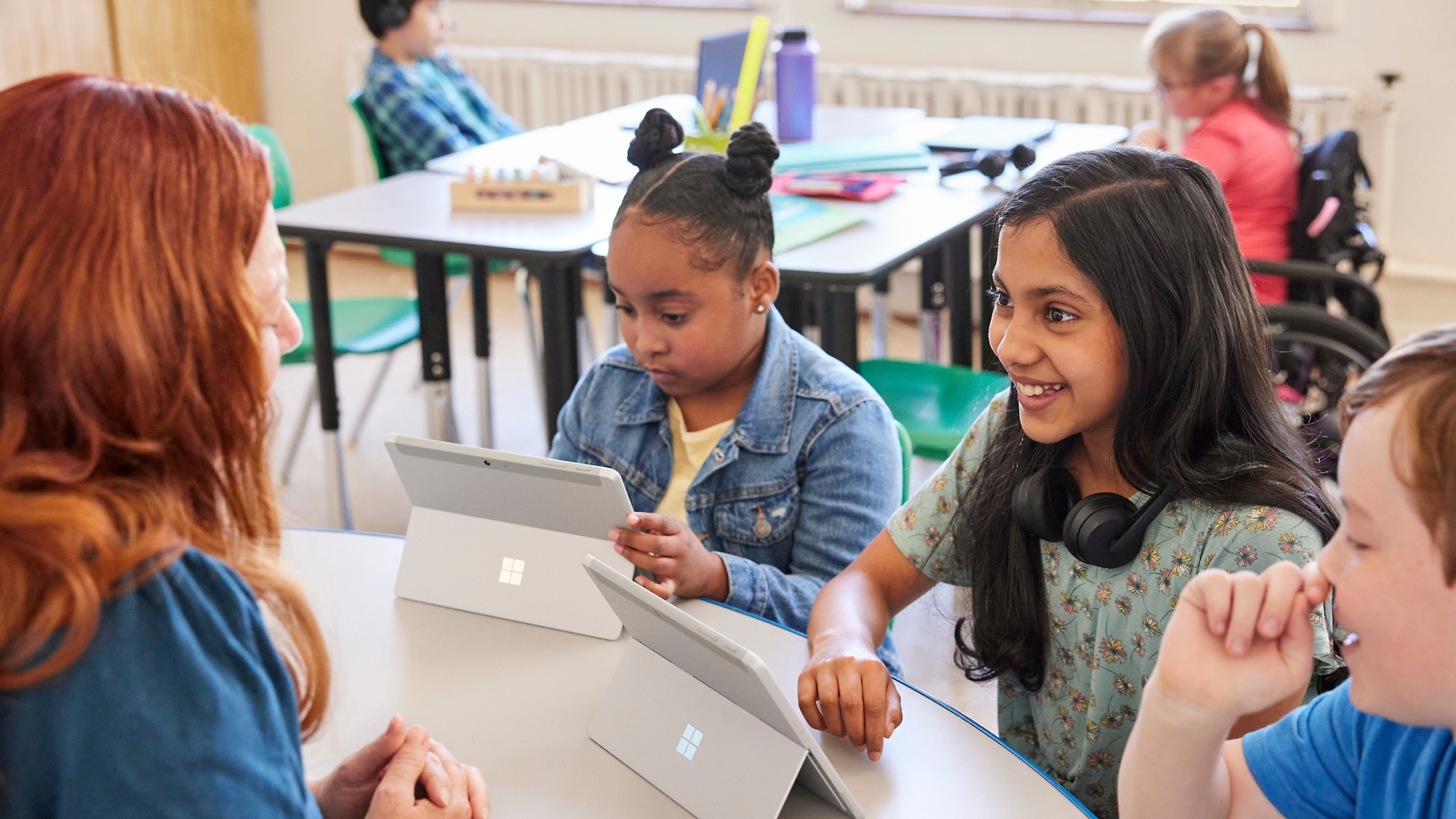 A group of children looking at a tablet