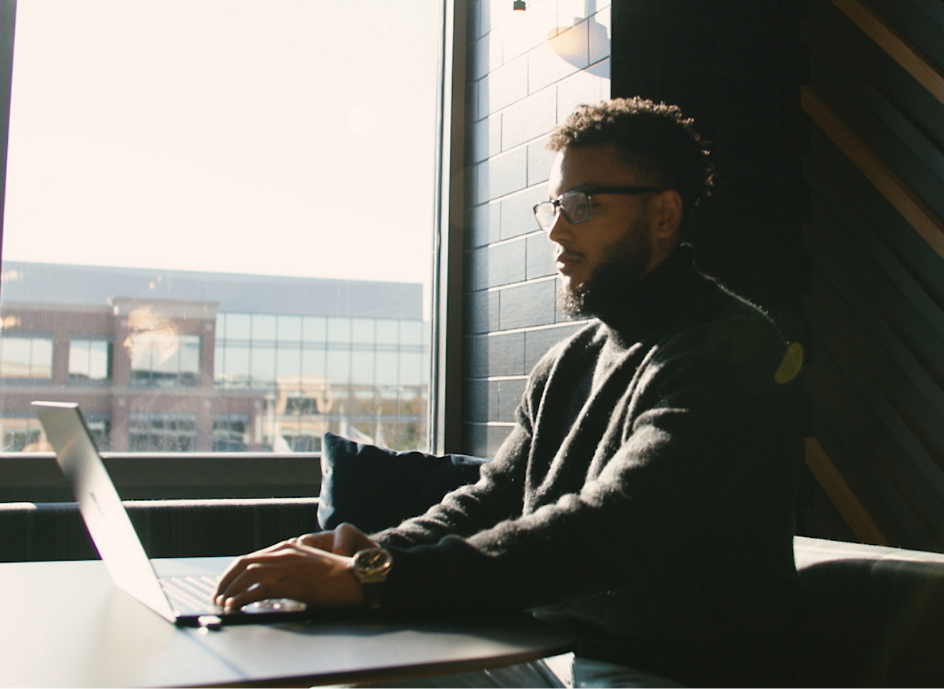 A man working on laptop in an office.