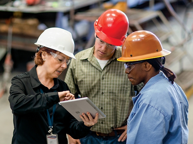 A group of people wearing hard hats.