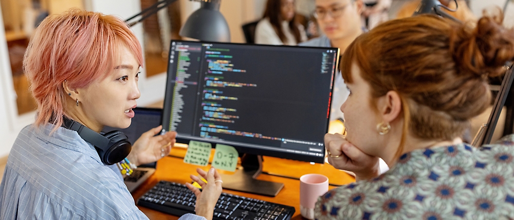 A group of people looking at a computer screen