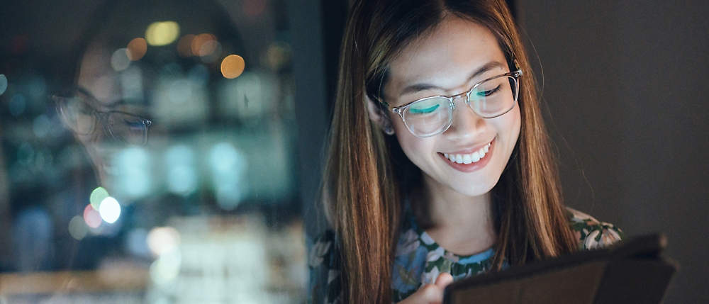 A person smiling at her phone