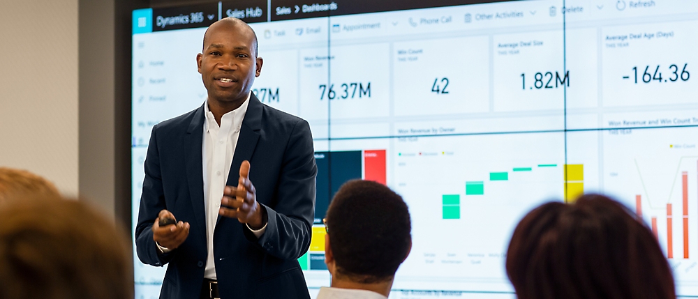 A person in a suit giving a presentation