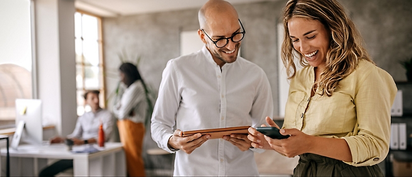 A man and women looking at a tablet