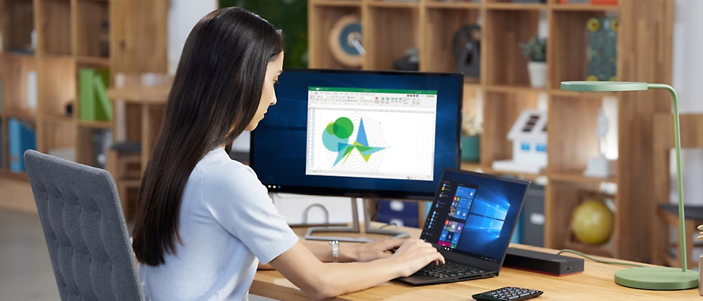 A person sitting at a desk using a computer