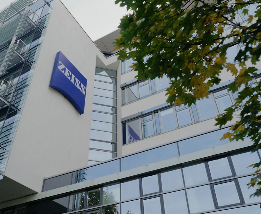 Modern office building with a zeiss sign on the facade.