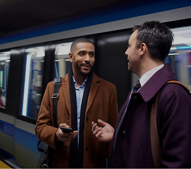 A group of men standing in a subway