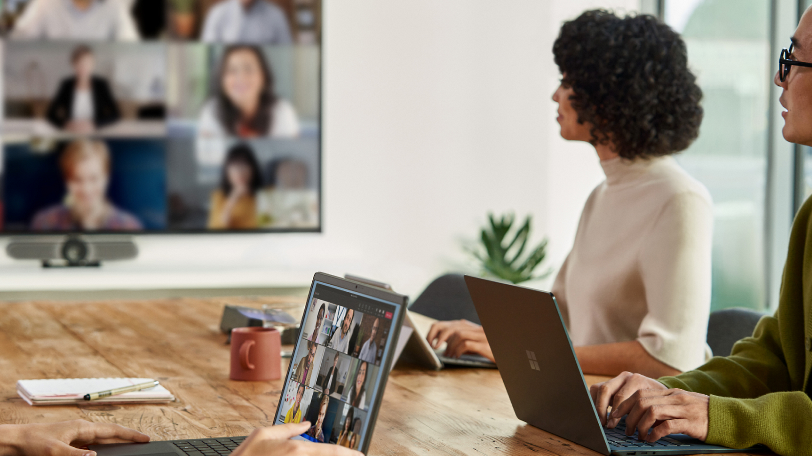 A group of people using laptops and attending a video conference