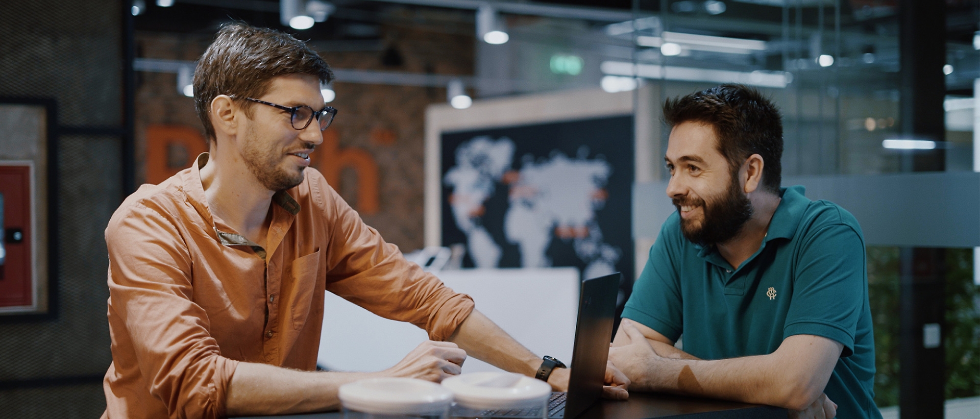 A couple of men looking at a computer