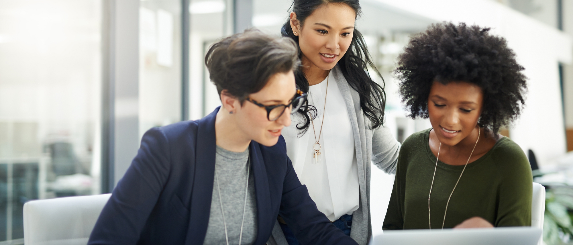 A group of women looking at a compute