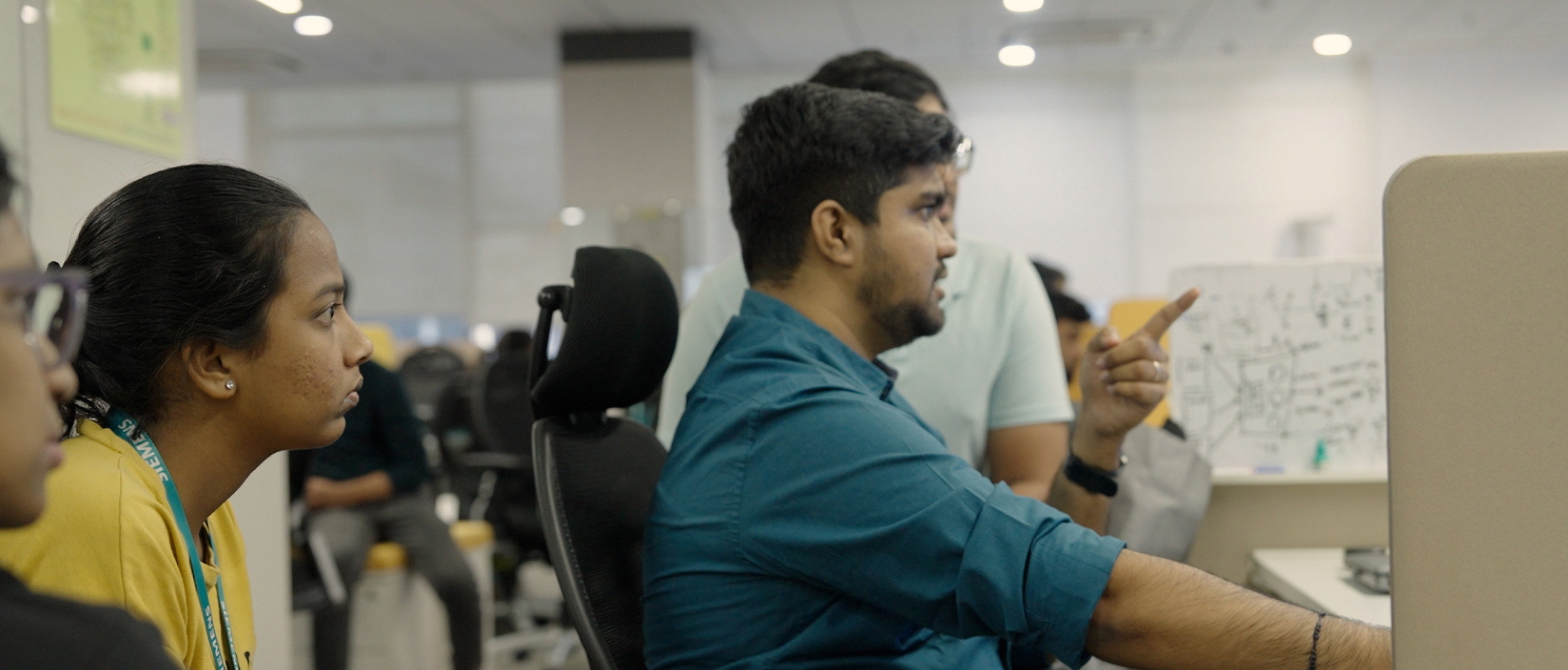 A group of people sitting at a desk