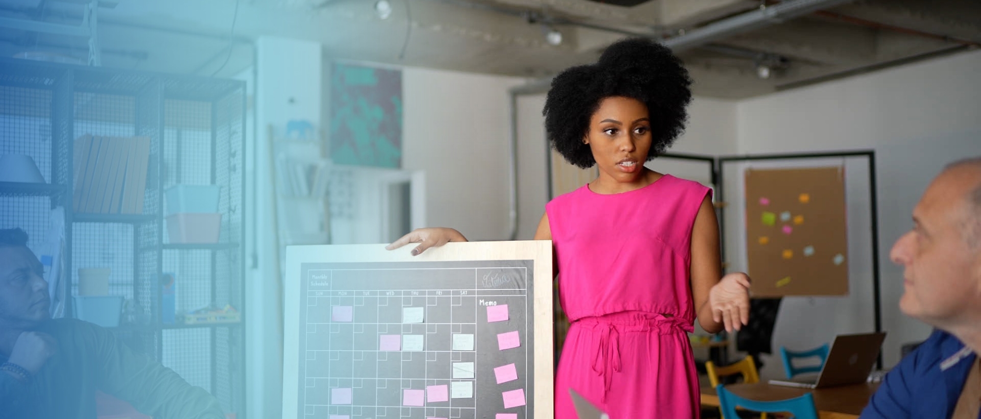 A person in a pink dress holding a board