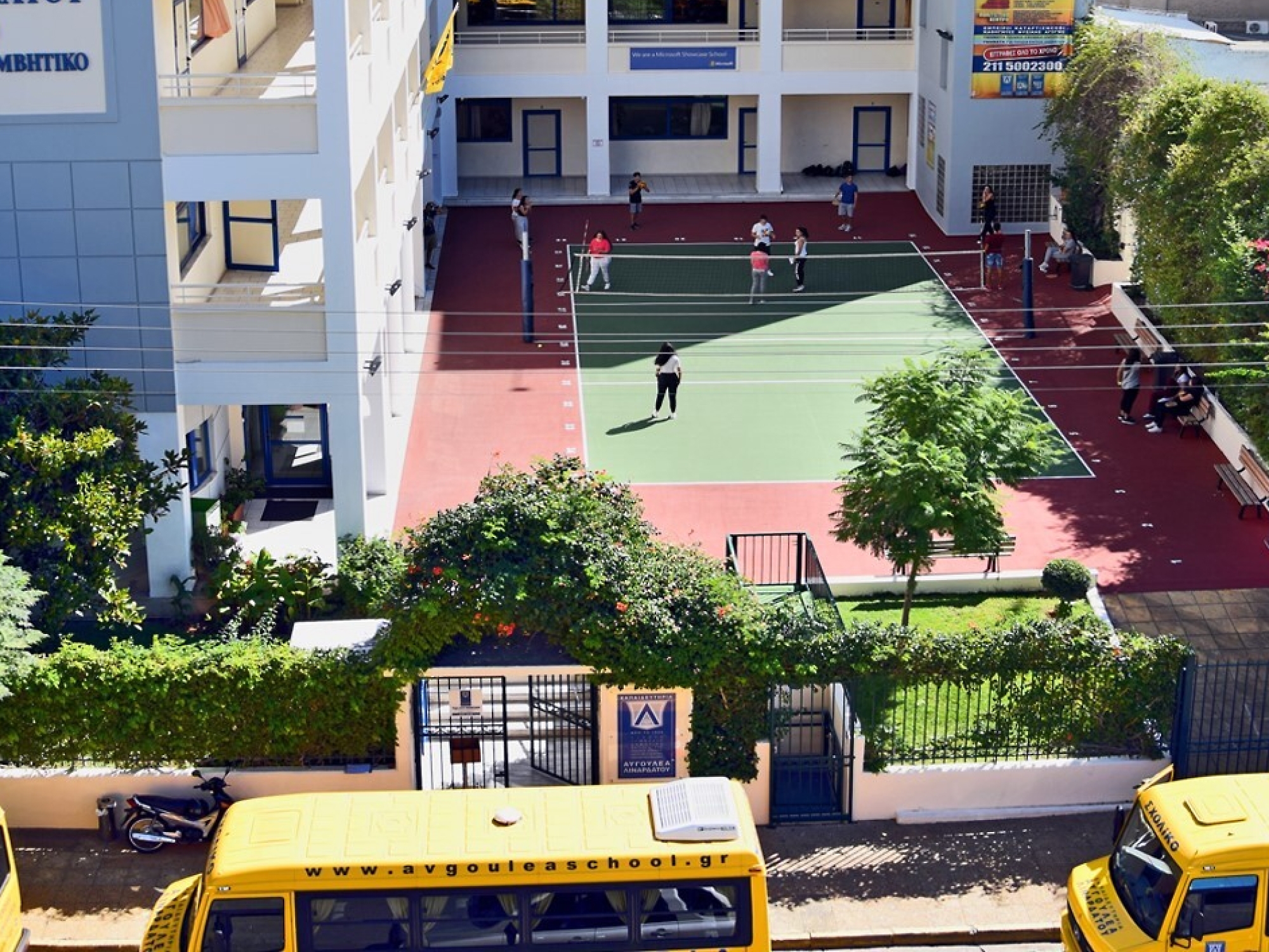 A group of people playing tennis in a court.