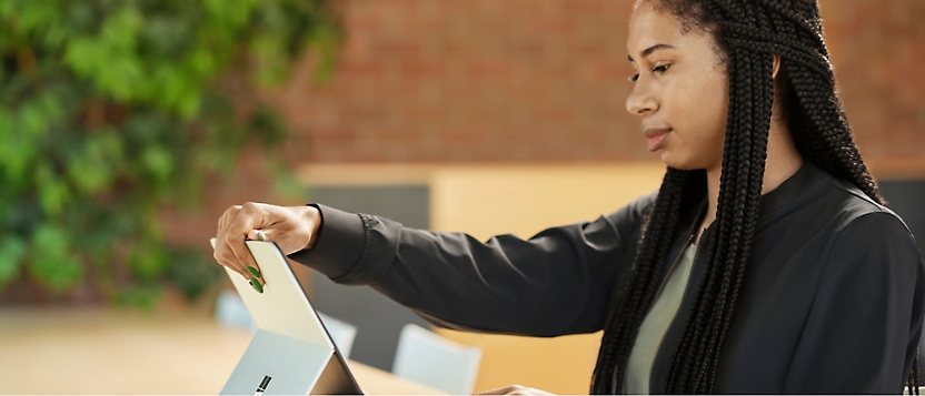 A person holding a tablet.