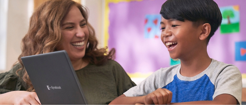 A person and a child looking at laptop.