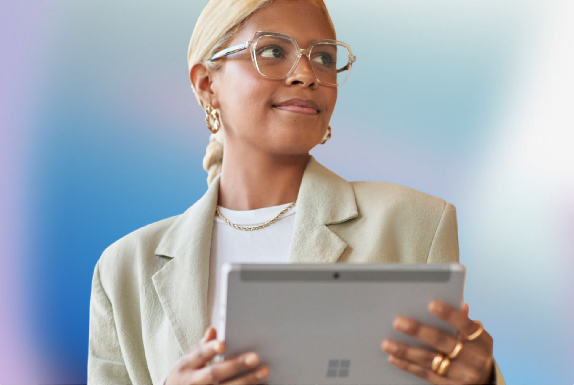 A girl with specs having a laptop in her hand