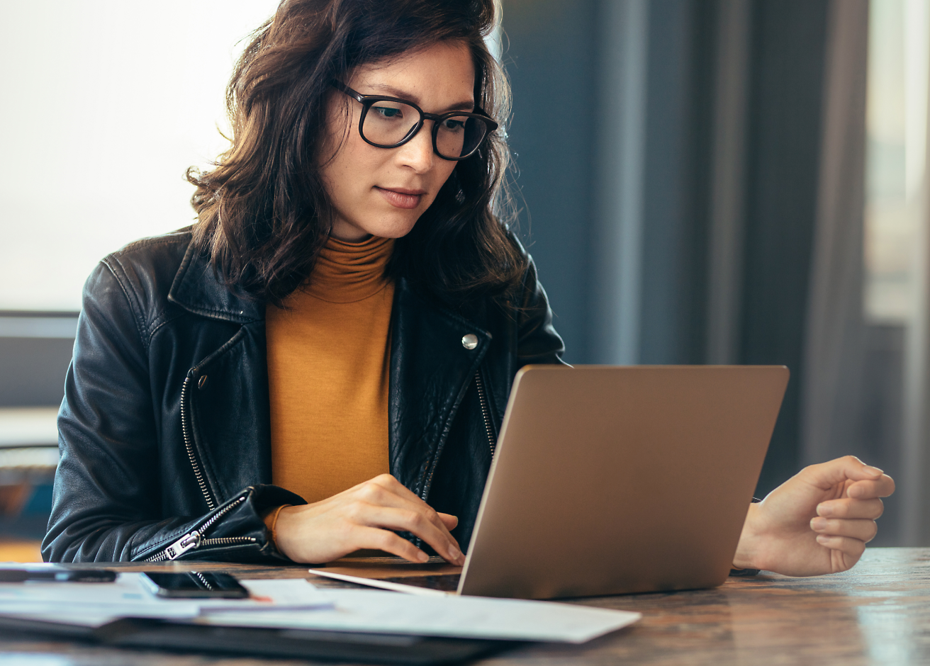 A person in glasses using a computer