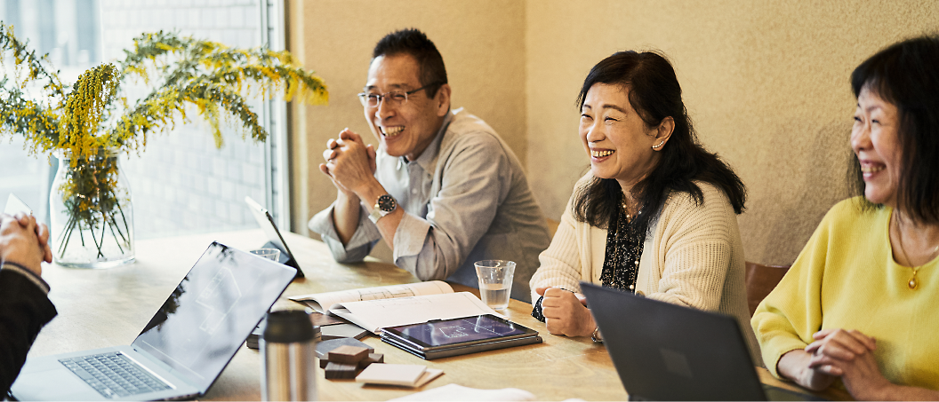 A group of people sitting at a table and laughing