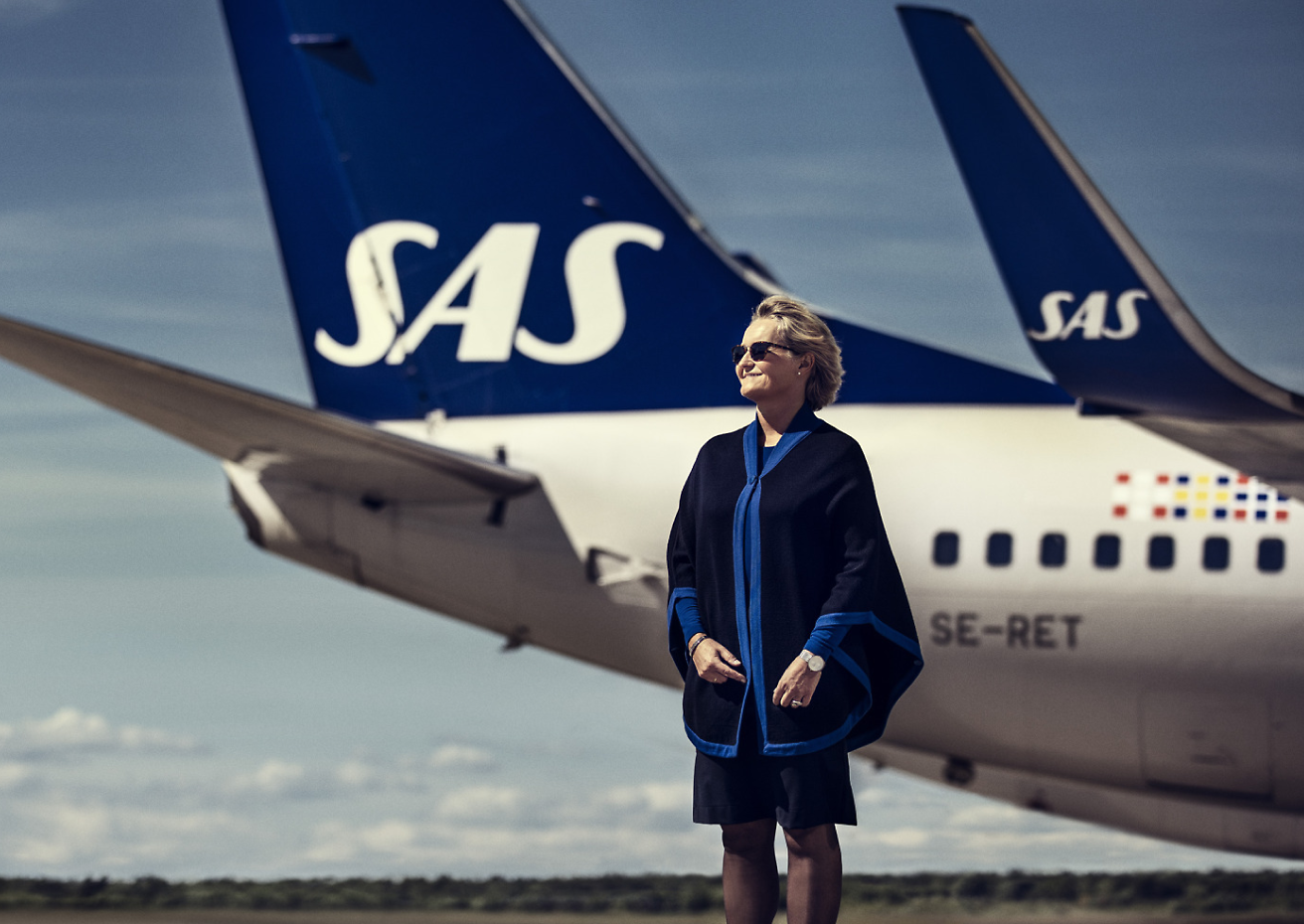 A person standing in front of a plane