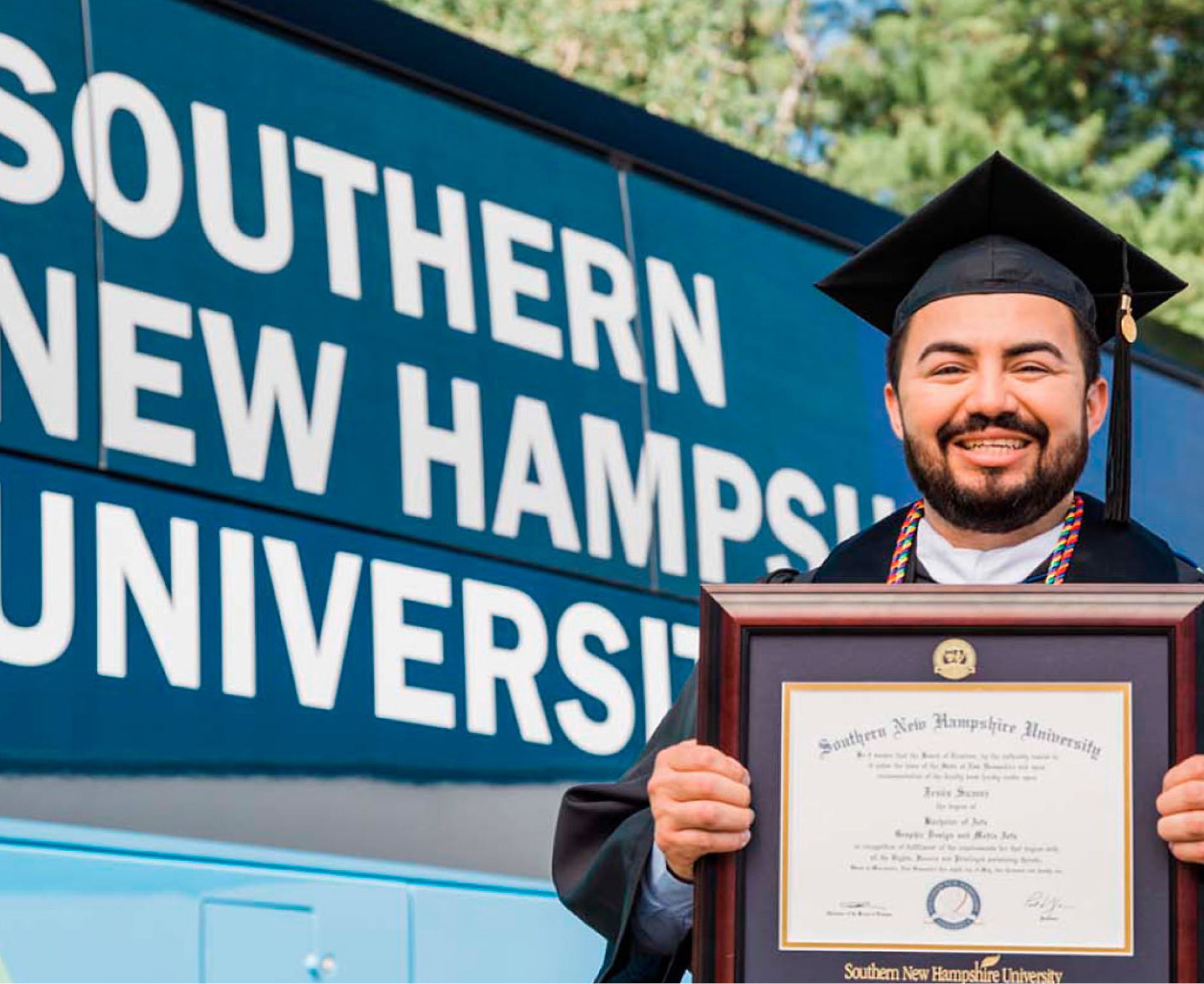 A person in a graduation gown holding a diploma.