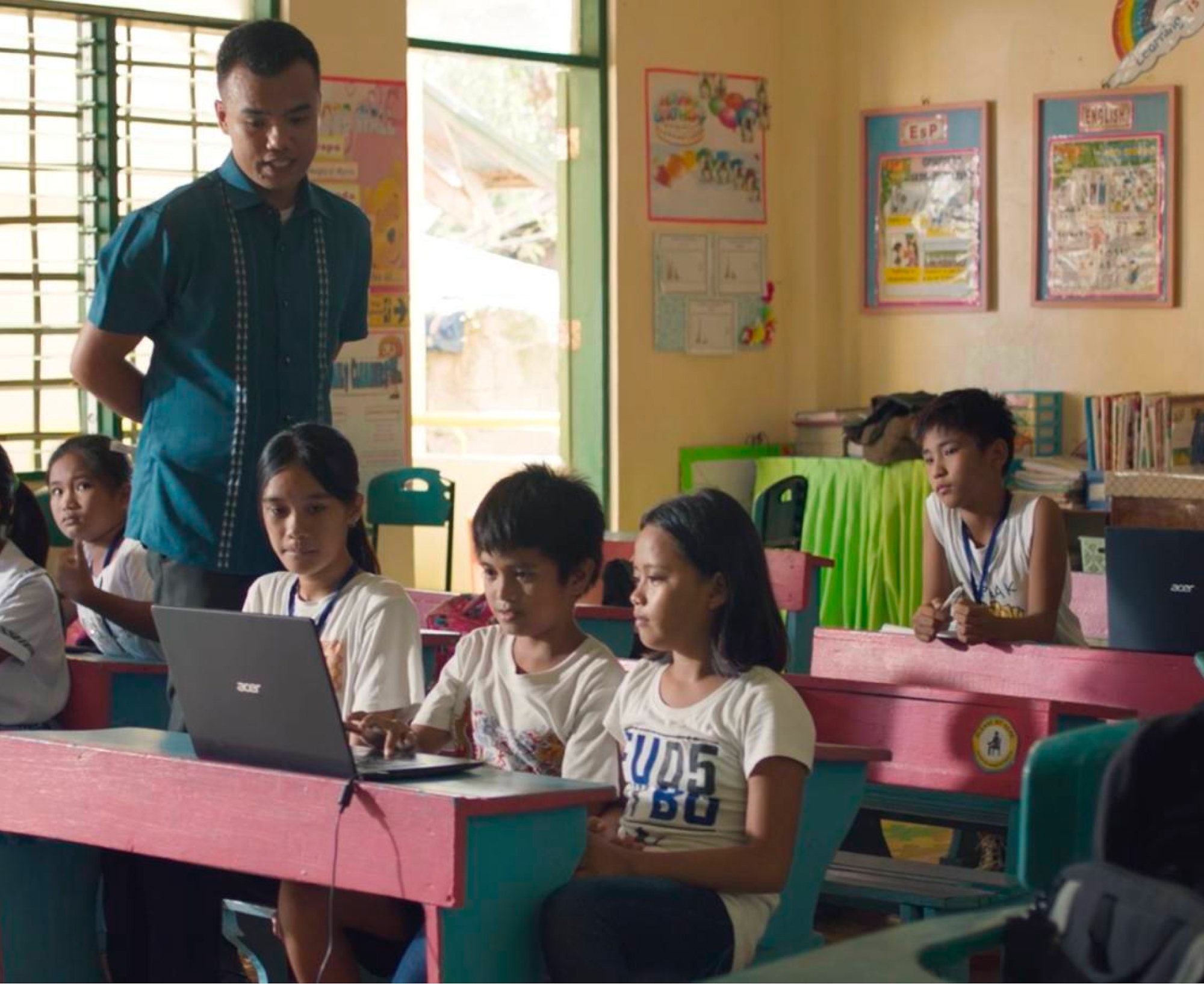 A group of children sitting at desks in a classroom.