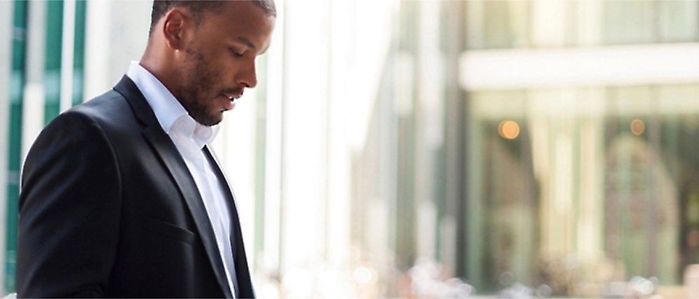 A person in a suit looking down