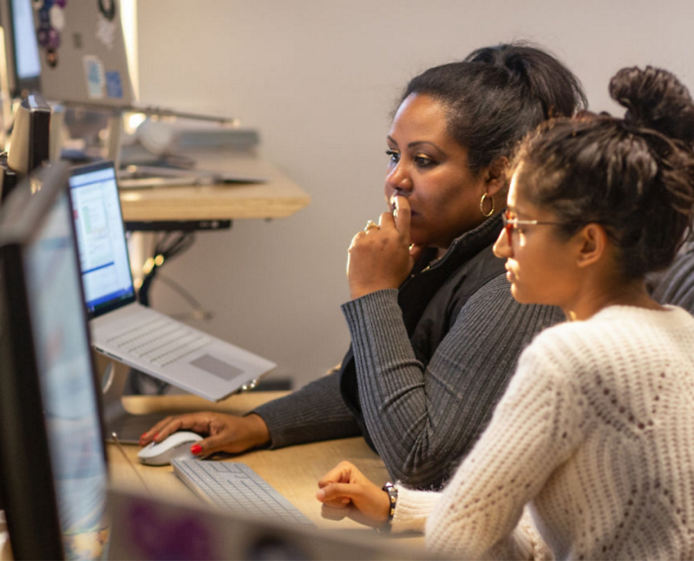 Two person's looking at a computer screen