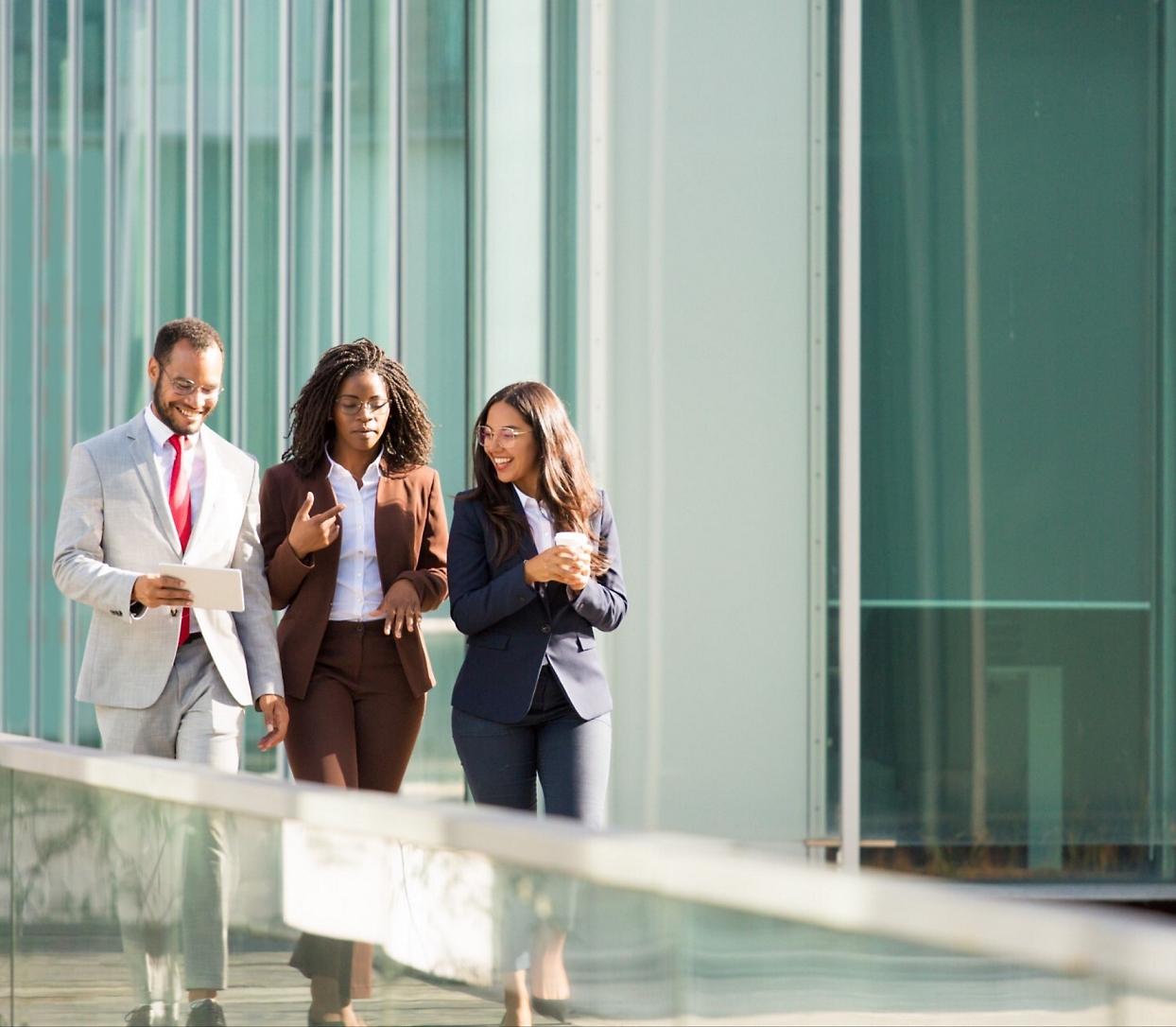 A group of people walking outside a building.